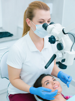 Cheerful patient undergoing teeth treatment with professional dentist stock photo