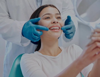 Young woman checking her results in the dentists office