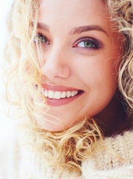 portrait of beautiful woman with curly hair and adorable smile