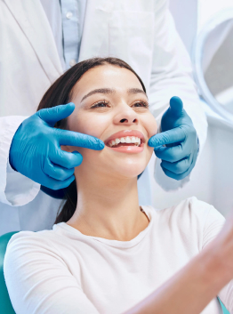 young woman checking her dental results in a dentist's office